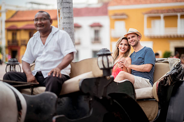 istock Loving couple riding on a carriage while traveling 626643140
