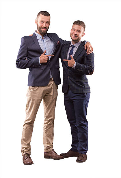 Two men in suits hugging stock photo