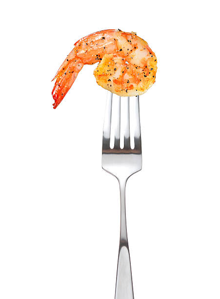 Cooked shrimp on fork Cooked shrimp on fork isolated on white background prawn seafood stock pictures, royalty-free photos & images