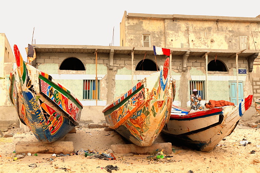 Guet Ndar, St.Louis, Senegal-April 19, 2014: Two wolof men take a rest at their home.s door on the beach-port of Guet Ndar while waiting for their fishing piroque to come back with the day.s captures.