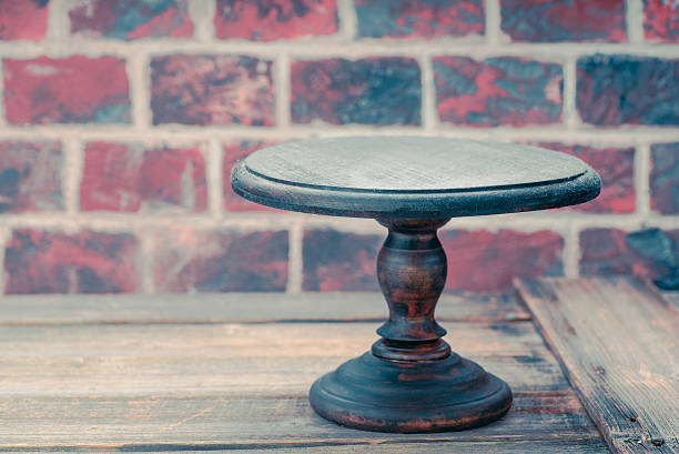 istock Cake plate on vintage wooden table over brick wall background 626657842