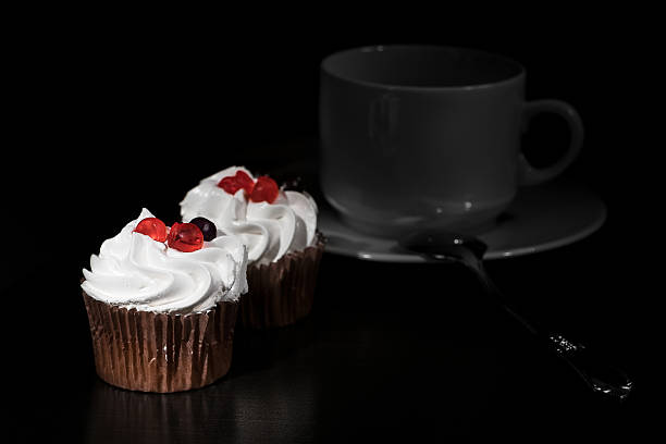 istock white cream cakes with red berry on top dark background 626659468