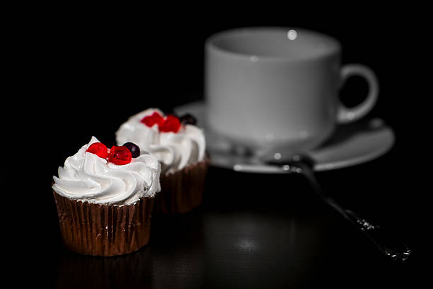 istock Two white cakes from cream with red berry on top 626659520