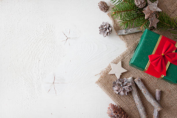 istock Christmas decoration on burlap textrure on white wood background 626659836