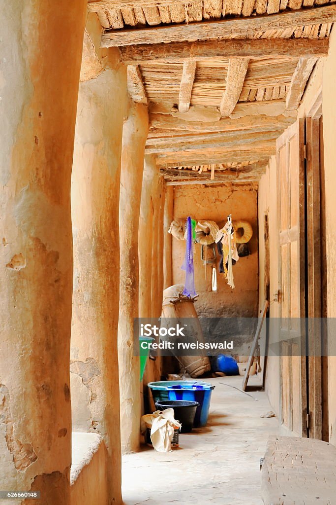 Terrace with pillars-maman Martine Diedhiou.s case a etages. Mlomp-Oussuye-Senegal. 2307 The cases a etages-two story houses made of mud are a characteristic feature of Mlomp village of Diola people as this of maman Martine Diedhiou.s in the image with columned terrace. Casamance-Senegal. Africa Stock Photo