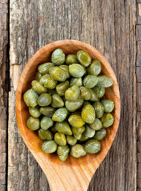 istock capers in a wooden spoon 626661326