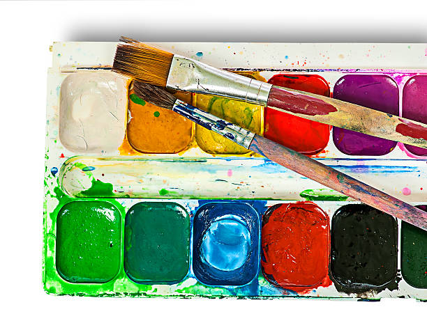 closeup of watercolor paints set and brushes - artists canvas yellow white red imagens e fotografias de stock