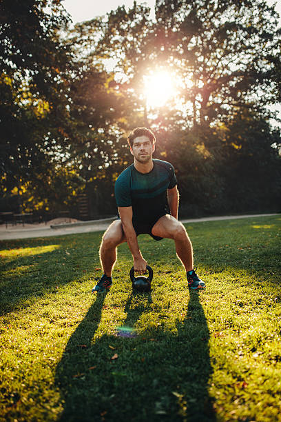 istock Strong man exercising with kettle bell in the park 626666608