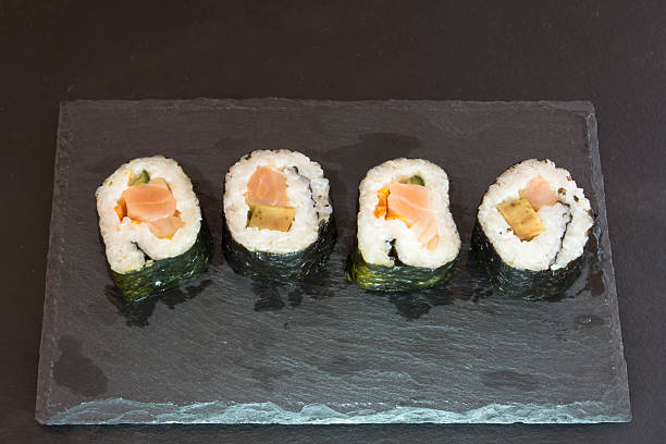 istock Pieces of sushi on a black stone 626667266