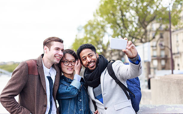 istock Multi-ethnic group of friends having fun in Paris along Seine 626667540