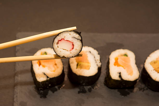 istock Pieces of sushi on a black stone 626668176