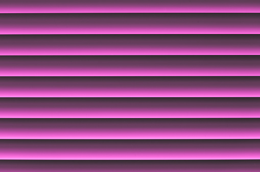 Fine purple pink or purplish pinkish violet jalousie venetian blind with mild daylight falling through close-up. Fine artistic backgrounds of almost gray resulting from various rough construction materials, technical materials. This image is part of a collection of different color shaded versions using the abstract spectrum of HSL, HSV and RGB in different color shades. These graphical elements serve as stylish design screen saver backdrop, backgrounds or anything alike.