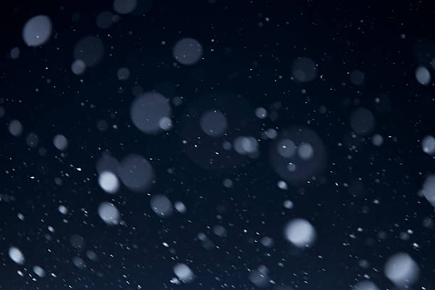 istock snowflakes against dark sky 626669602