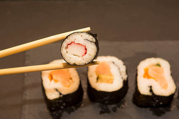 istock Pieces of sushi on a black stone 626669844