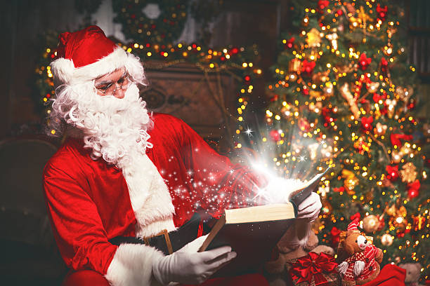istock Santa Claus at Christmas with magical book 626670170