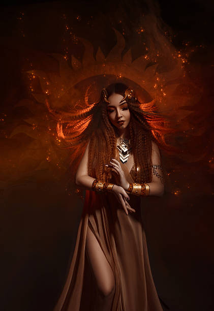 Beautiful, red-haired girl - a priestess of the sun. Dress and jewelry in ethnic style. Unusual make-up in orange and gold tones. Fantastic photography, fashionable toning.