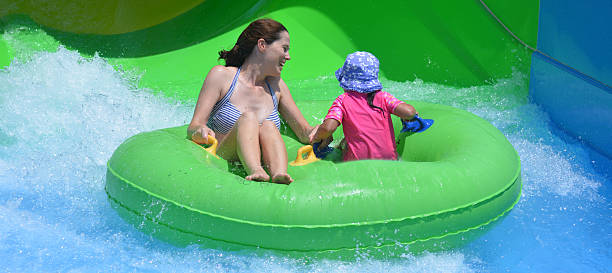 istock Mother and child having fun in water park 626672628
