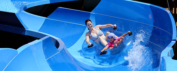 istock Mother and child having fun in water park 626673162
