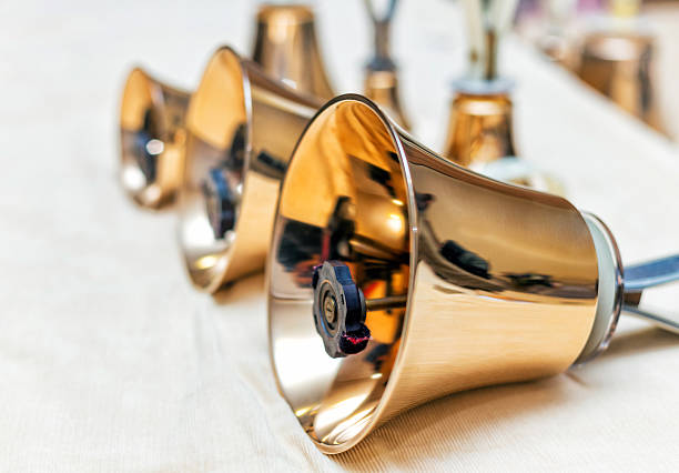 Set of gold handbells on table during concert. Christmas time