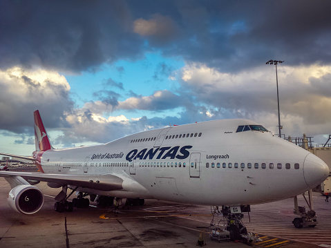 Sydney, Australia - Dec 22, 2015: A Qantas Jumbo 747-400 Longreach docked to the jetway at Sydney's Kingsford-Smith Internatioal Airport. Qantas is the flagship carrier airline of Australia.