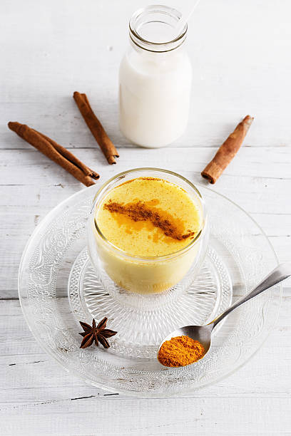 istock Turmeric latte over white wooden table 626679976