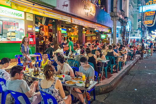 Bangkok, Thailand - February 23, 2016: An outdoor restaurant crowded with tourists on Khao San Road in Bangkok.  Khao San Road is a world famous backpacker street.