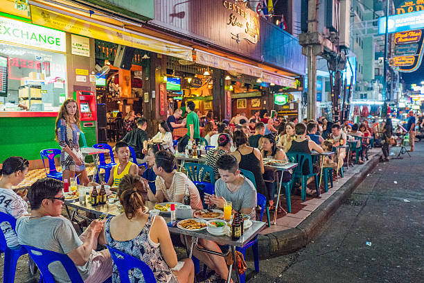 Khao San Road, Bangkok Bangkok, Thailand - February 23, 2016: An outdoor restaurant crowded with tourists on Khao San Road in Bangkok.  Khao San Road is a world famous backpacker street. khao san road stock pictures, royalty-free photos & images