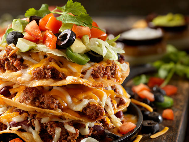 Chilli Cheese Tostada Tower Chilli Cheese Tostada Tower - Photographed on Hasselblad H3D2-39mb Camera nacho chip stock pictures, royalty-free photos & images