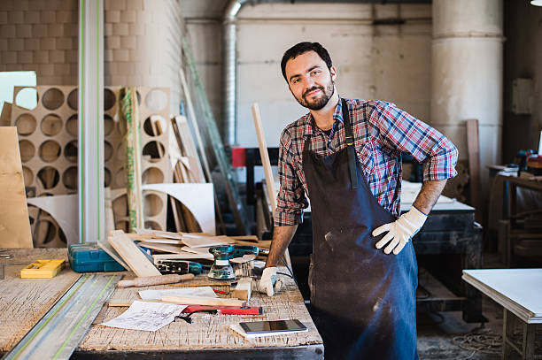 istock Carpenter working carefully looking at the plans 626685504