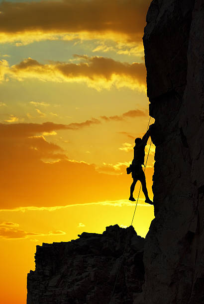 istock Silhouette of a climber over beautiful sunset 626685948