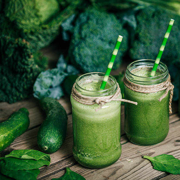 istock Blended green smoothie with ingredients on wooden table 626692046