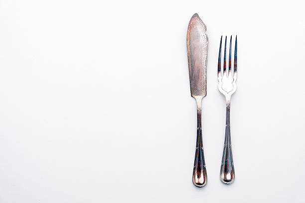 istock knife and fork isolated on white - beautiful silver cutlery 626692728