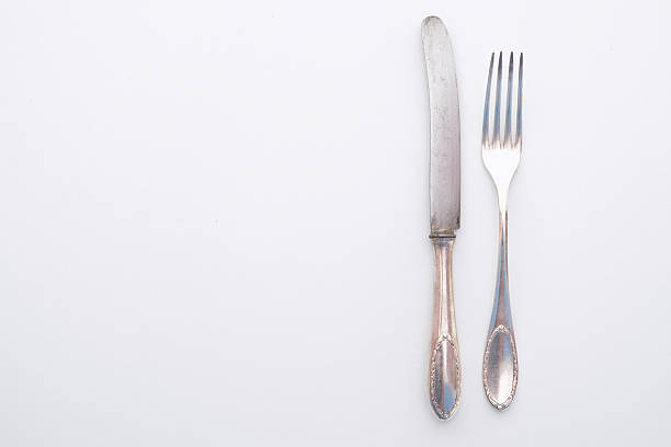 istock knife and fork isolated on white - beautiful silver cutlery 626692784
