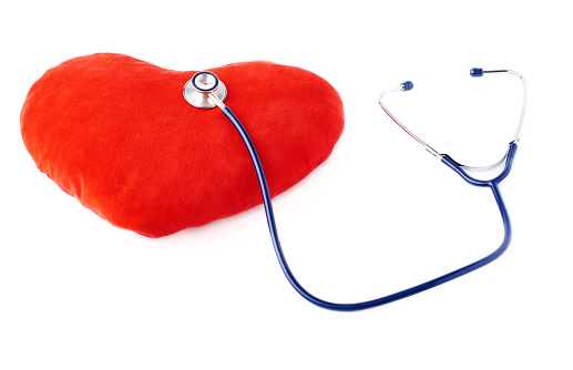 Red heart and stethoscope on white