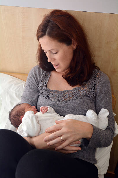 Mother holding her just born baby Girl.