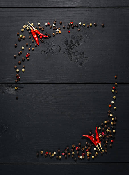 Spices, papper on black wooden background. Top view. Free space.