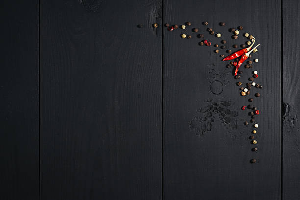 istock Spices, papper on black wooden background. Top view. Free space. 626697548