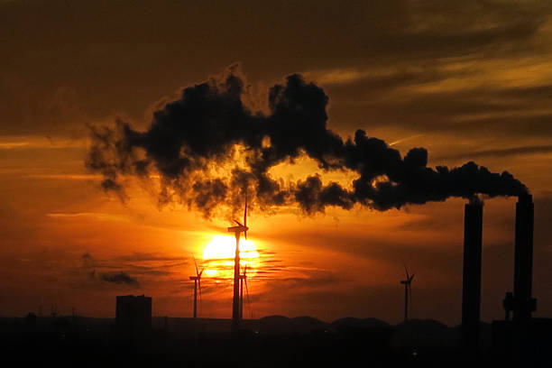 istock Industry and technology- wind turbines, factory at orange sunset 626697588
