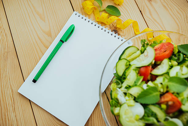istock Diet plan, menu or program, tape measure and diet food. 626698196