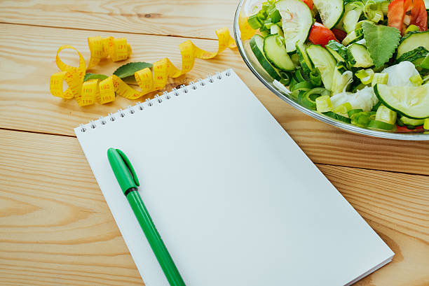 istock Diet plan, menu or program, tape measure and diet food. 626698250