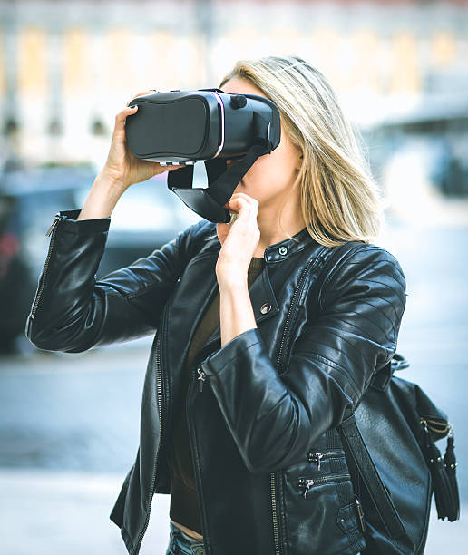 istock Women testing Virtual Reality simulator on the street 626700078