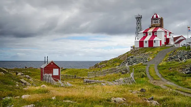Cape Bonavista Lightstation, Newfoundland, Canada.  Lighthouse station LL 449, tip of cape Bonavista on Atlantic coast. Navigational aid to ships.  Beacon at end of rocky shoreline at cape's end.