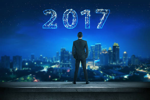 istock Back view business man looking 2017 on the sky 626707276