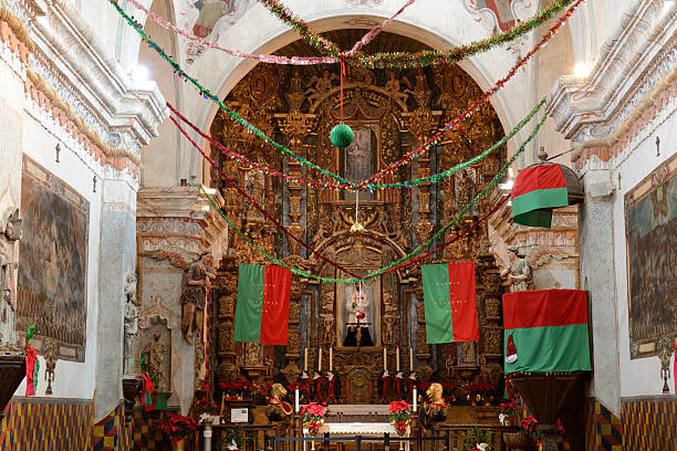 Christmas Decoration inside San Xavier Mission Interior of San Xavier Mission with Christmas decoration, Tucson, Arizona, USA. San Xavier Mission is a Catholic mission founded in 1692. It is a national historic landmark located 9 miles south of downtown Tucson. The mission 's interior is filled with original statues and mural paintings of 18th century. It is a popular tourist destination. tucson christmas stock pictures, royalty-free photos & images