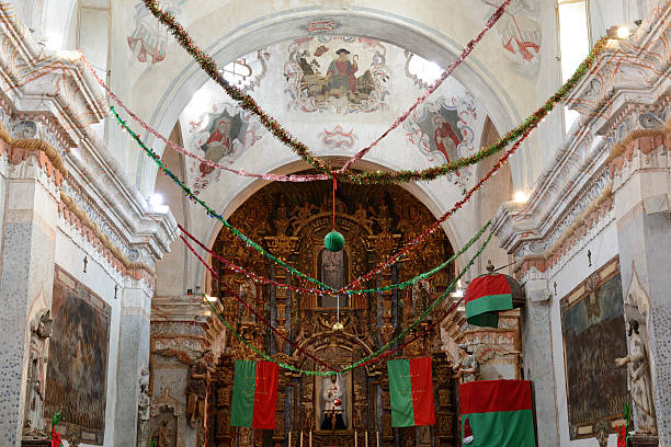 Interior of San Xavier Mission with Christmas decoration Interior of San Xavier Mission with Christmas decoration, Tucson, Arizona, USA. San Xavier Mission is a Catholic mission founded in 1692. It is a national historic landmark located 9 miles south of downtown Tucson. The mission 's interior is filled with original statues and mural paintings of 18th century. It is a popular tourist destination. tucson christmas stock pictures, royalty-free photos & images