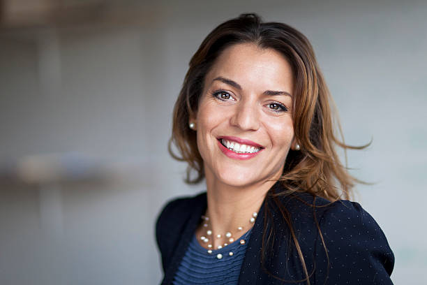 Spanish Businesswoman Smiling At the Camera. At the office. stock photo