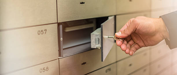 istock Hand holding key and opening small vault 626723290