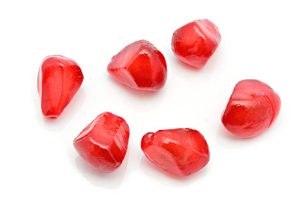 istock Closeup of pomegranate Seeds on white 626723504