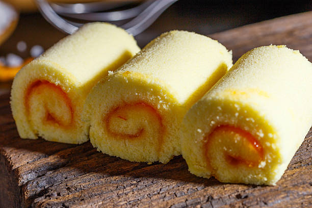 istock Yamroll orange on wood plate and black background 626740030