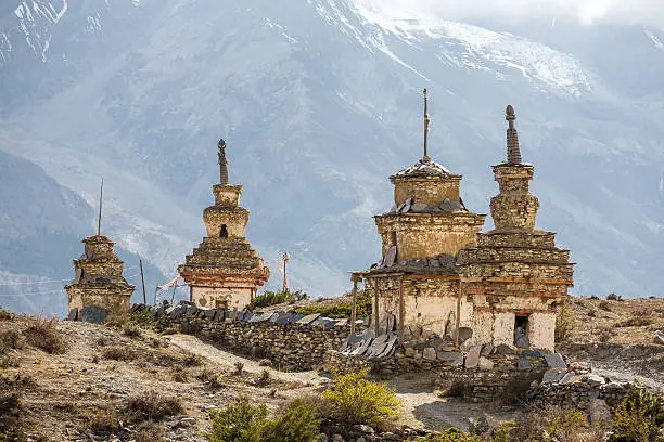 Traditional old Buddhist stupas on Annapurna Circuit Trek in Himalaya mountains, Nepal.